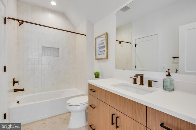 full bathroom with toilet, lofted ceiling, tiled shower / bath combo, and vanity