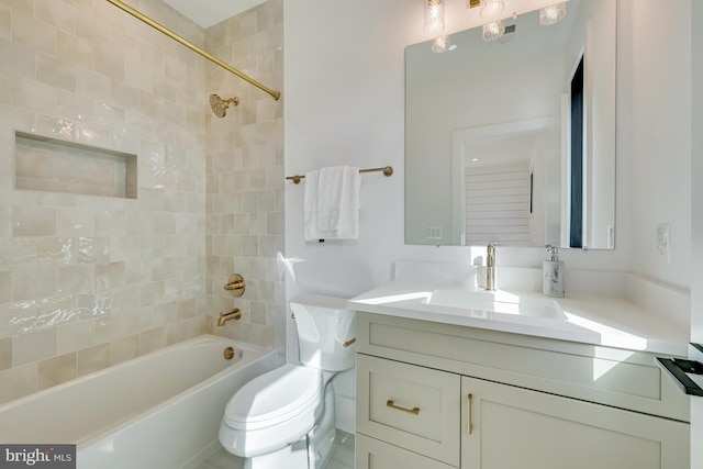 full bathroom with vanity, tiled shower / bath combo, and toilet