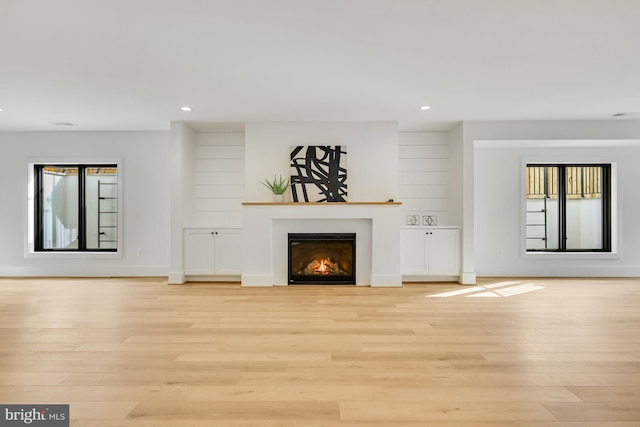 unfurnished living room with light wood-type flooring