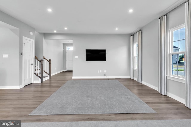 unfurnished living room with dark hardwood / wood-style flooring