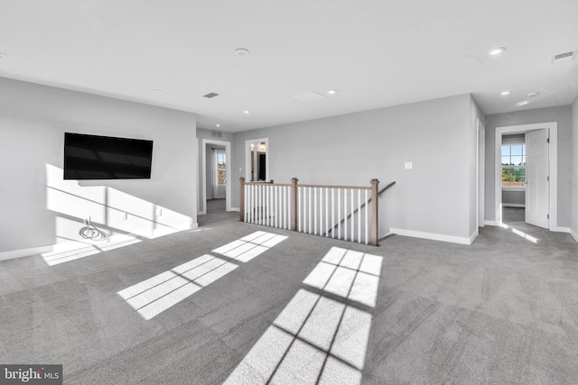 unfurnished living room featuring carpet flooring