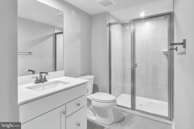 bathroom with vanity, toilet, and walk in shower