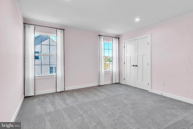 carpeted empty room featuring a healthy amount of sunlight