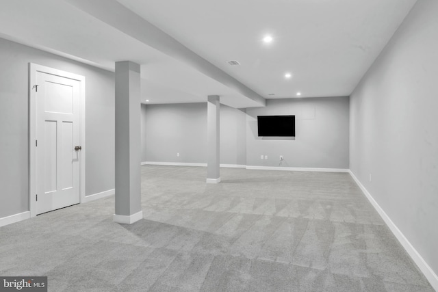 basement featuring light carpet