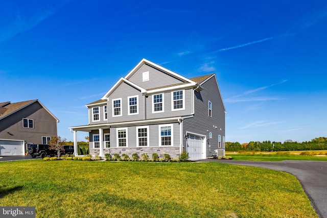 view of front of home with central air condition unit, a front yard, and a garage