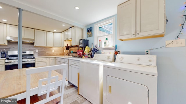 laundry room with light hardwood / wood-style flooring and washer and clothes dryer