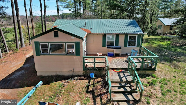 rear view of property featuring a deck