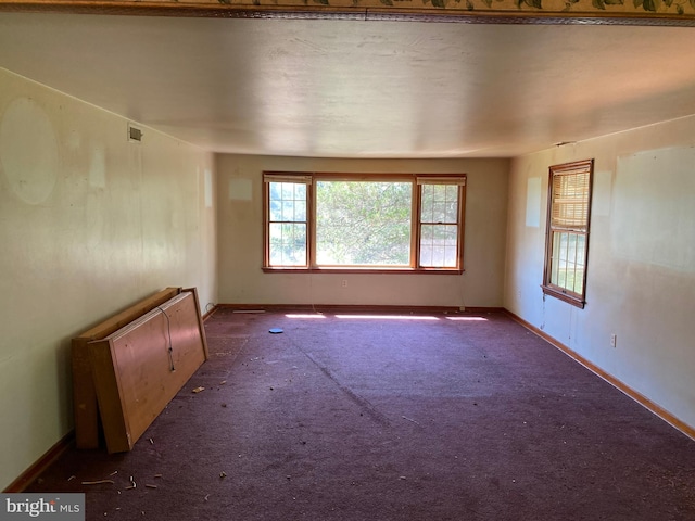 empty room with dark colored carpet