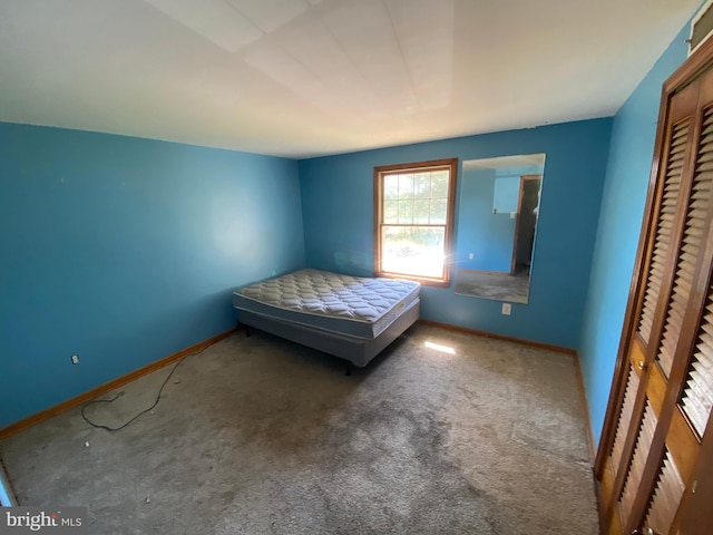 unfurnished bedroom with a closet and carpet