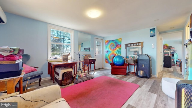 interior space featuring an AC wall unit and light hardwood / wood-style flooring