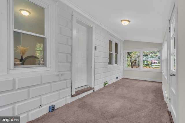 unfurnished sunroom featuring vaulted ceiling