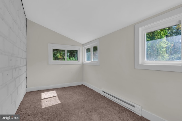 empty room with vaulted ceiling, baseboard heating, and carpet floors