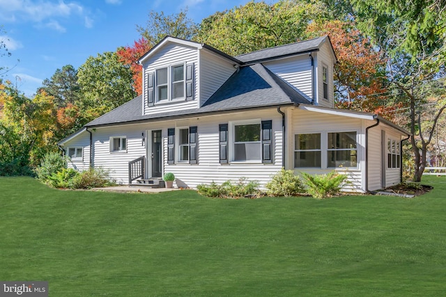 back of house featuring a yard