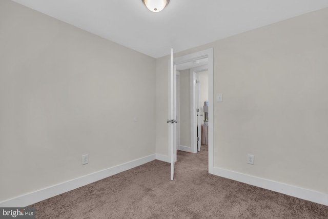 unfurnished room with light carpet