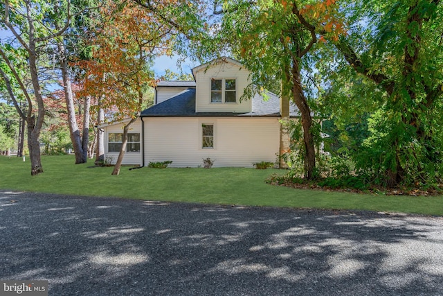 view of property exterior with a yard