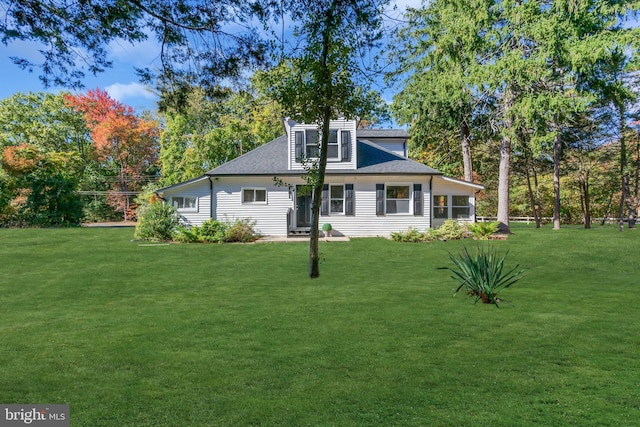 rear view of house with a yard