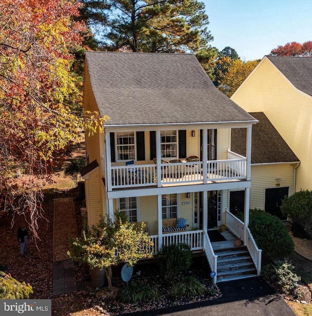 view of front of property featuring a balcony and a porch