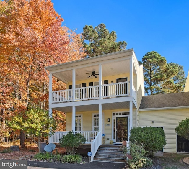 view of front of home featuring covered porch, ceiling fan, and a balcony