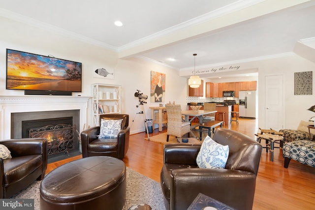 living room with light hardwood / wood-style floors and crown molding