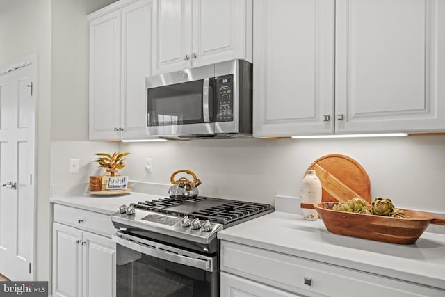 kitchen with stainless steel appliances and white cabinetry