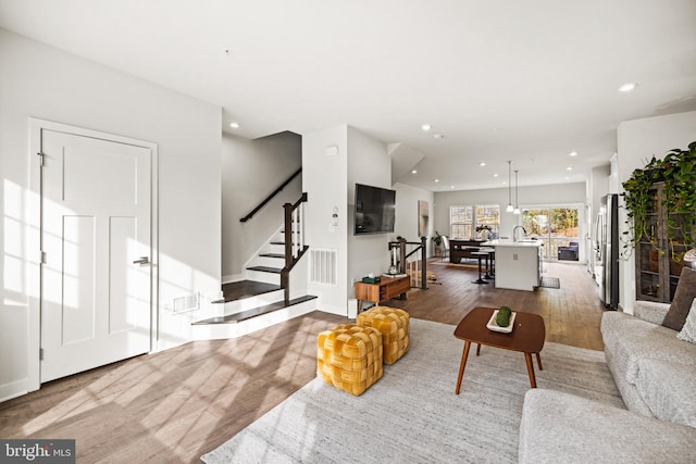 living room with sink and hardwood / wood-style floors