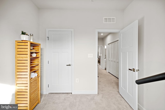 unfurnished bedroom with light colored carpet