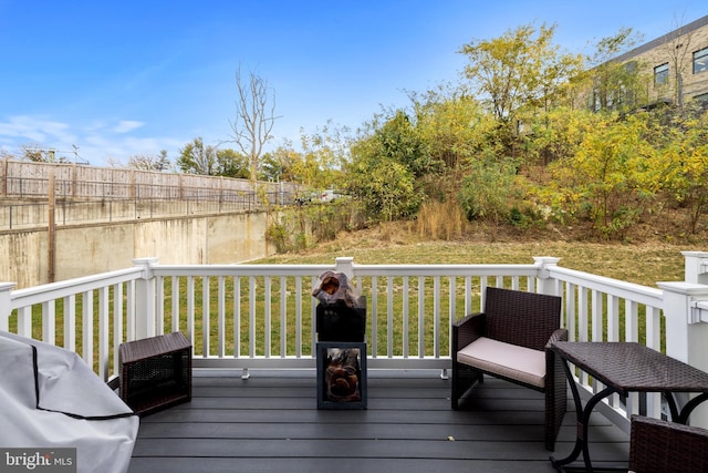 deck featuring a water view and a lawn