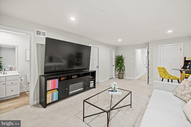 living room with sink and light hardwood / wood-style flooring