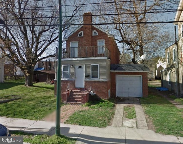 view of front of property with a garage, a front yard, and a balcony