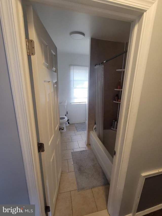 bathroom with shower / tub combo with curtain and tile patterned floors