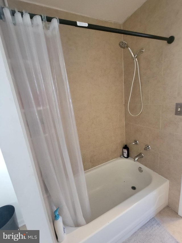 bathroom with shower / bath combination with curtain