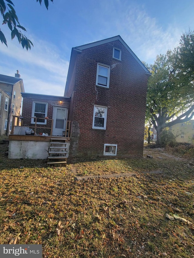 back of property featuring a deck