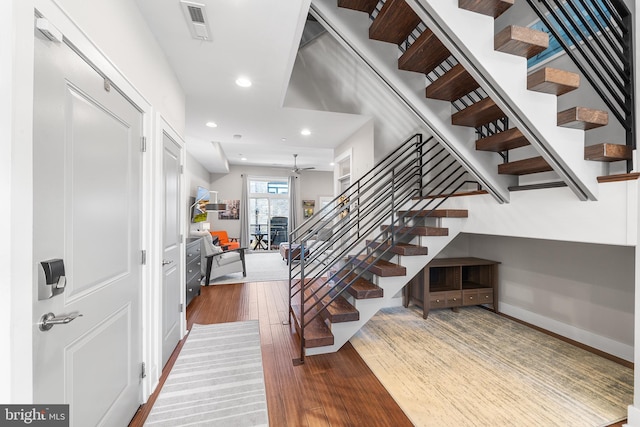 stairway featuring hardwood / wood-style flooring