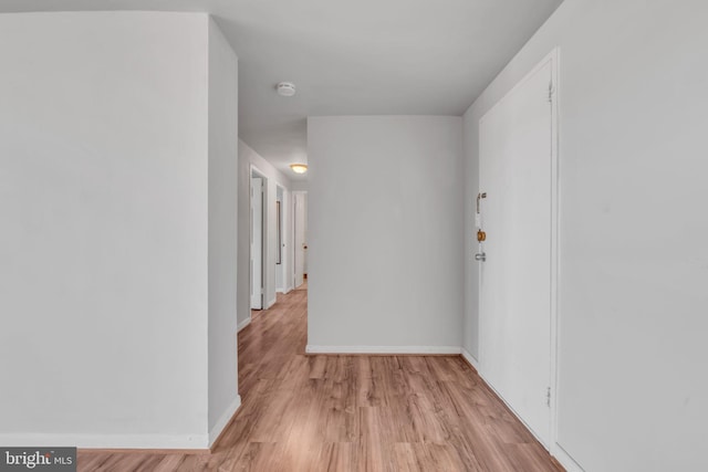 corridor with light wood-type flooring