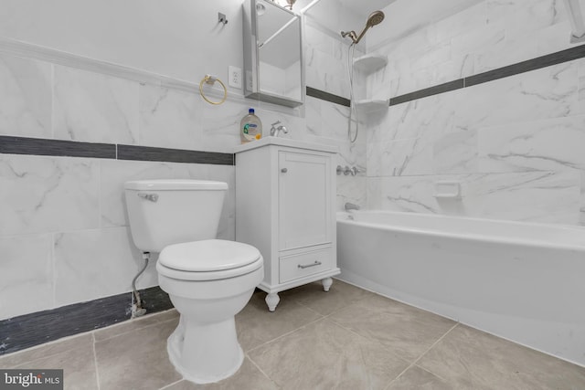 full bathroom with tile walls, vanity, tiled shower / bath combo, and toilet