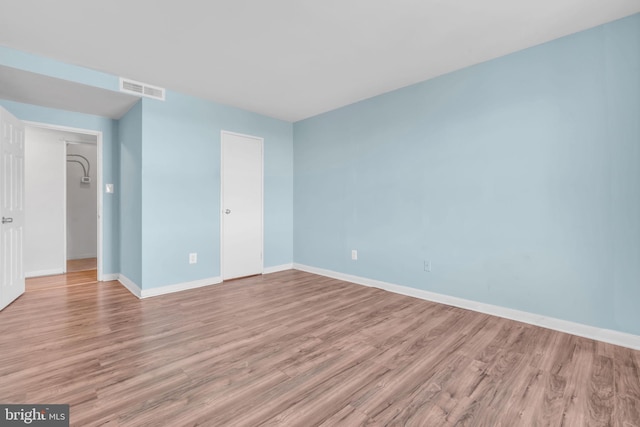 spare room with light hardwood / wood-style floors