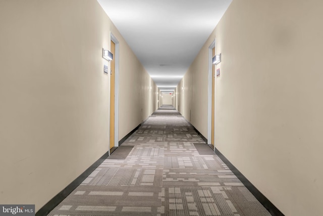 hall with light colored carpet