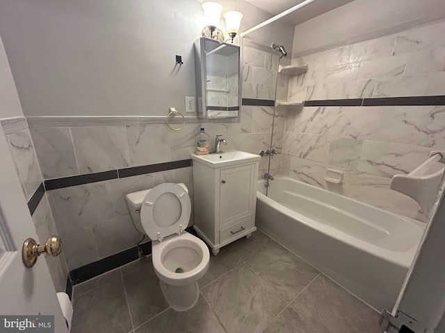 full bathroom featuring vanity, tiled shower / bath combo, tile walls, and toilet