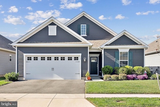 craftsman-style house with a garage and a front lawn