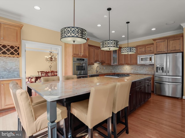 kitchen with stainless steel appliances, light wood-style floors, ornamental molding, and light stone countertops