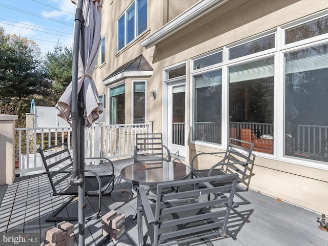 wooden deck featuring outdoor dining area