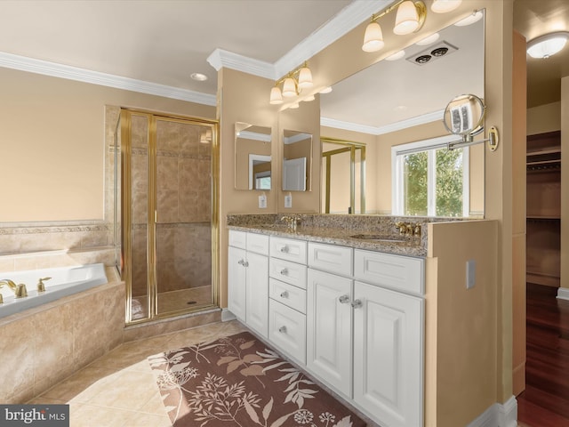 bathroom featuring a stall shower, a sink, and crown molding