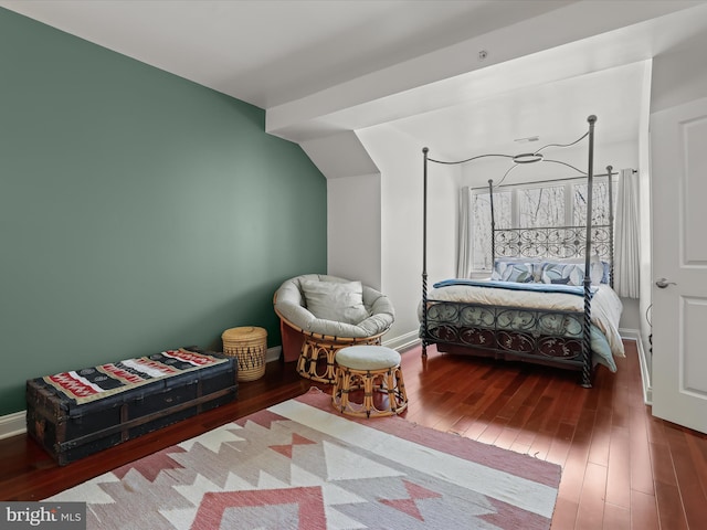 bedroom featuring hardwood / wood-style floors and baseboards