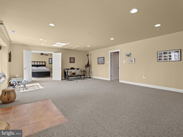 interior space with baseboards, visible vents, a ceiling fan, carpet flooring, and recessed lighting