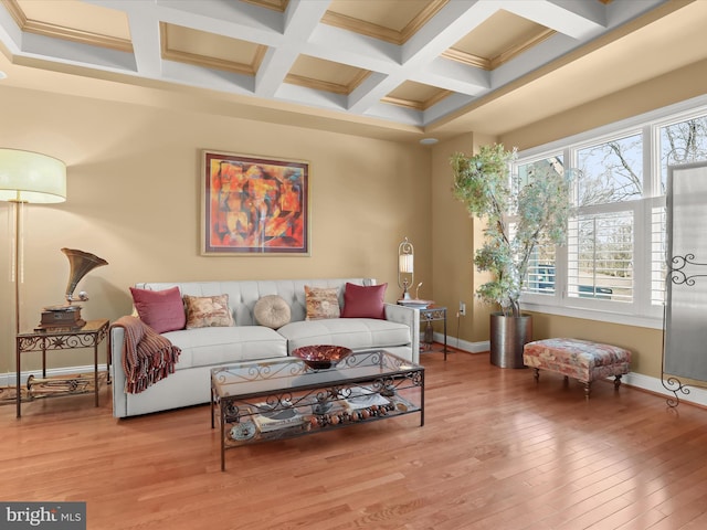 living area with beam ceiling, coffered ceiling, baseboards, and wood finished floors