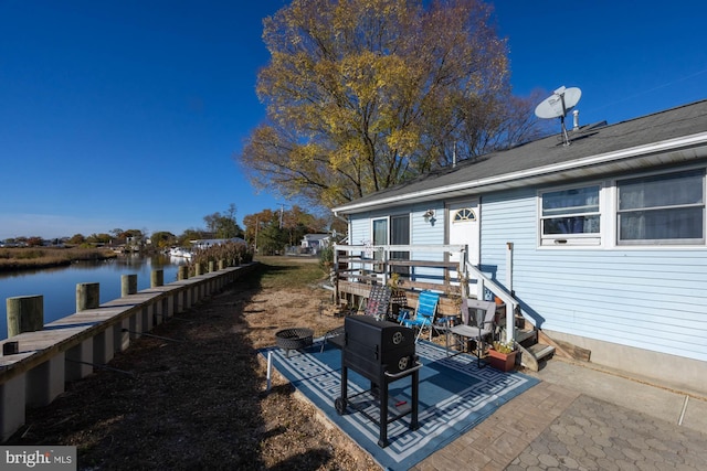 exterior space featuring a patio area and a water view