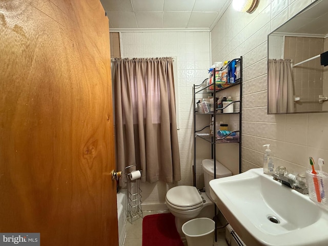 bathroom with toilet, tile walls, and sink