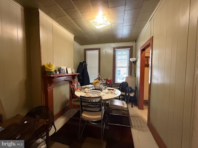 dining space with wood walls