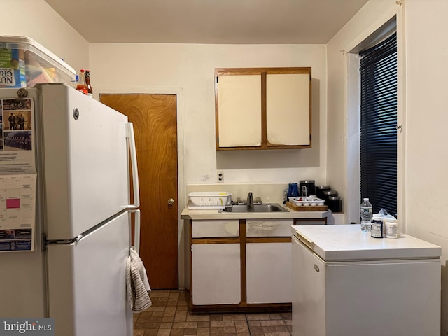 kitchen featuring sink, refrigerator, and white fridge