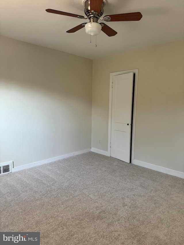 spare room with carpet floors and ceiling fan